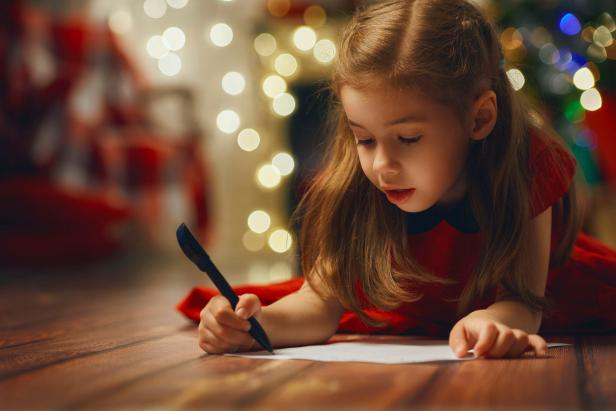 Young girl writing letter